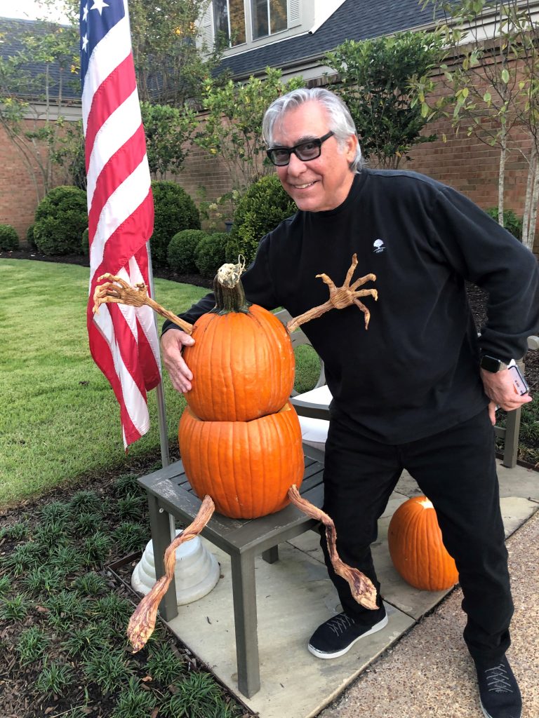 Author Michael hicks Posing With Headless Pumpkin